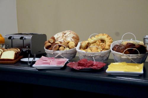 a table with baskets of different types of bread at Gardi Hotel & Suites in Buenos Aires