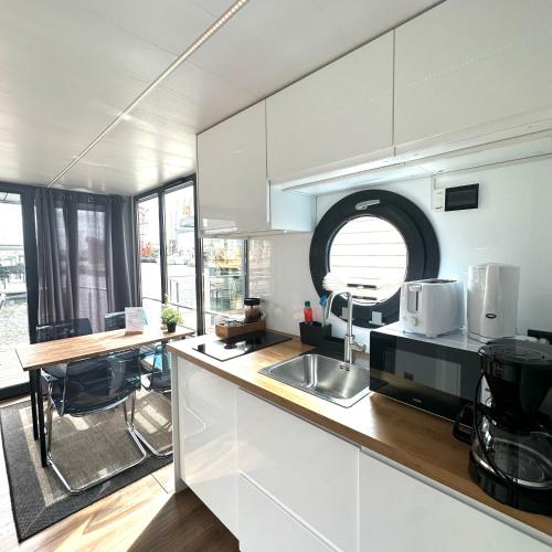 a kitchen with a sink and a counter top at La Mare Resort in Gothenburg