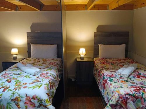 a bedroom with two beds and two lamps on the wall at Brix 7 single beds in Johannesburg