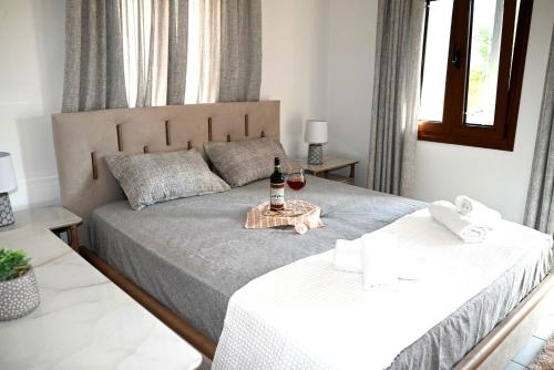 a bedroom with two beds with a bottle of wine at George Living House in Metsovo