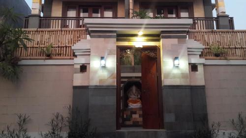 a dog sitting in the doorway of a house at Natha Ubud Villa in Ubud