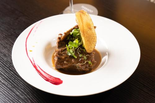 a white plate with a piece of food on a table at Hotel Terrado Cavancha in Iquique