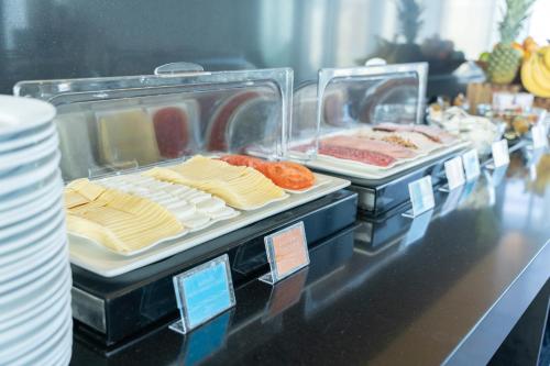 two trays of food sitting on a counter with food at Hotel Terrado Cavancha in Iquique