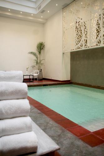 a swimming pool in a room with towels at Gardi Hotel & Suites in Buenos Aires