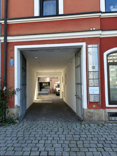an open garage door of a building with a parking lot at Wohnung Donau - im Zentrum, Küche, Parkplatz, ruhig gelegen in Passau