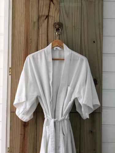 a white shirt is hanging on a wooden door at CasaIvan in Florianópolis