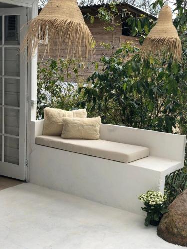a bench sitting on the porch of a house at CasaIvan in Florianópolis