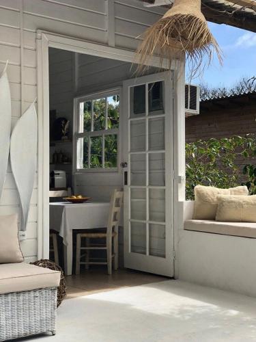 an open door to a patio with a table at CasaIvan in Florianópolis