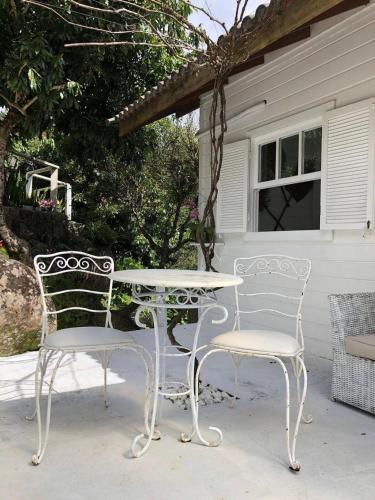 two chairs and a table on a patio at CasaIvan in Florianópolis