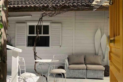 a patio with a table and chairs and a couch at CasaIvan in Florianópolis