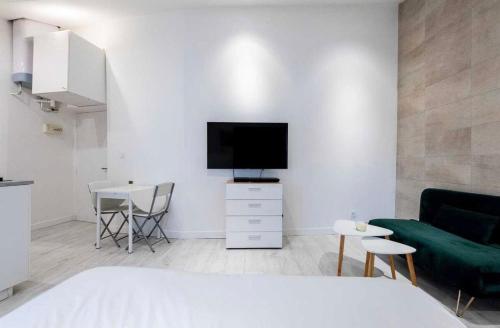 une chambre avec un lit, une télévision et une table dans l'établissement Suite Dali -Studio à Cannes, à Cannes