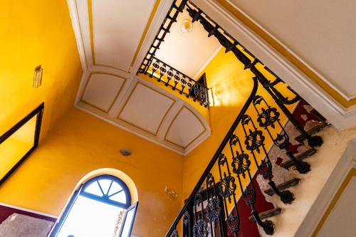 an attic room with a staircase and a window at Malìa Home in Catania