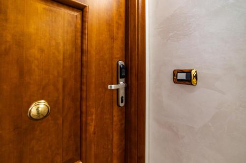 a wooden door with a lock on it at Malìa Home in Catania