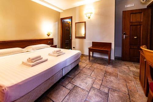 a bedroom with a bed with two towels on it at Malìa Home in Catania