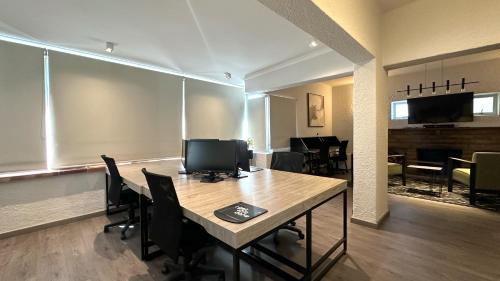 a room with a table with chairs and a television at Anchor Bay Workation in Cape Town