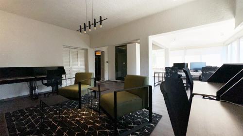 a living room with a piano and a table and chairs at Anchor Bay Workation in Cape Town