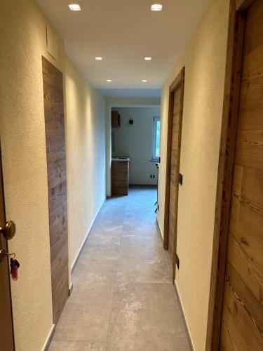 a hallway with two doors and a room with a floor at Miramonti Bellevue in Sauze dʼOulx