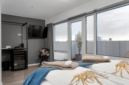 a bedroom with two beds and a flat screen tv at City Center Hotel in Reykjavík