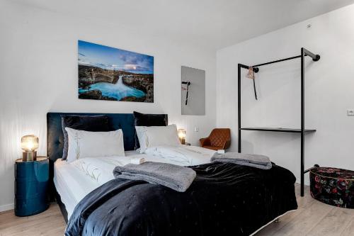 a bedroom with a large bed and a large painting on the wall at City Center Hotel in Reykjavík