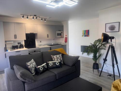 a living room with a couch and a kitchen at 38 Everton Road Free onsite parking in Liverpool