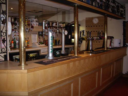 a bar in a pub with a counter top at Corn Mill Lodge Hotel in Leeds
