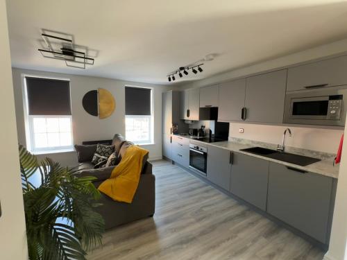 a living room with a couch and a kitchen at 38 Everton Road Free onsite parking in Liverpool