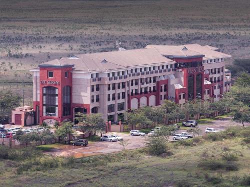 a large building with cars parked in a parking lot at 254 Ole Sereni-Nairobi Park View in Nairobi