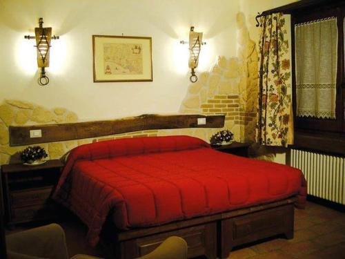 a bedroom with a red bed in a room at B&B Villa Fiorita in Roccaraso