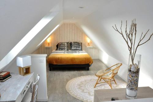 a bedroom with a bed in a attic at Maison de charme 3 étoiles avec jardin clos terrasse PERROS-GUIREC - ref 869 in Perros-Guirec