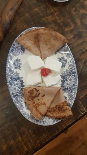 a plate of food with three slices of cheese at B&B Il Gattonero in Arcumeggia