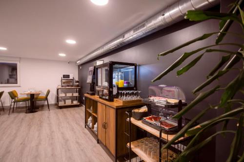 a room with a counter and a table with chairs at U-Hotel Darío Lugo in Lugo