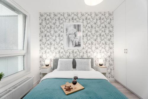 a bedroom with a bed with a tray on it at Warsaw City Family Premium in Warsaw