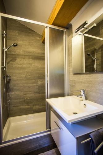 a bathroom with a sink and a shower at Ferienwohnung Walder in Außervillgraten