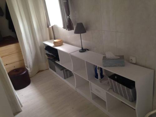 a white counter in a room with a lamp on it at Maison COLETTE in Villardonnel