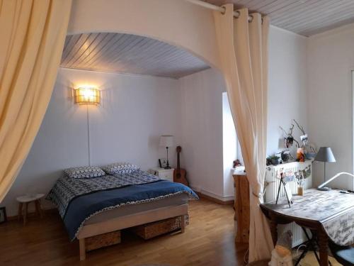 a bedroom with a bed in a room with a window at Maison COLETTE in Villardonnel