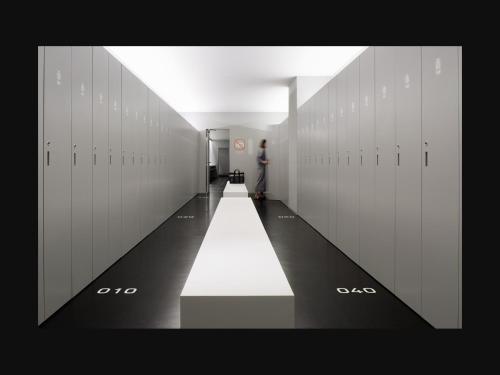 a hallway with white lockers in a building at 9h nine hours Narita Airport in Narita