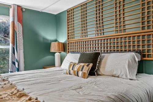 a bedroom with a large bed with a wooden headboard at Chic Cypress View Cabin Wkayaks & Canoes in Karnack
