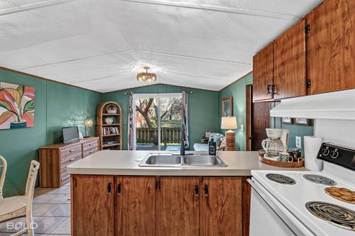 a kitchen with a sink and a stove at Chic Cypress View Cabin Wkayaks & Canoes in Karnack