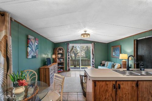 a kitchen with green walls and a counter top at Chic Cypress View Cabin Wkayaks & Canoes in Karnack