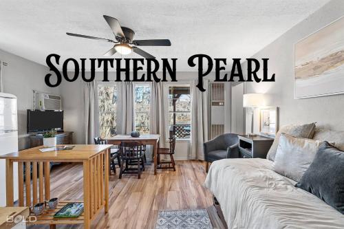 a living room with a southern pearl sign on the wall at Chic Cypress View Cabin Wkayaks & Canoes in Karnack