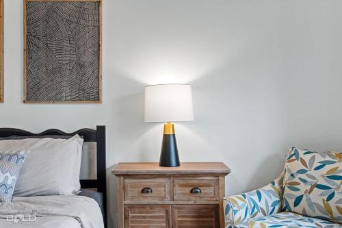 a lamp on a night stand next to a bed at Cool Moss Stone Lodge Wkayaks & Canoes in Karnack