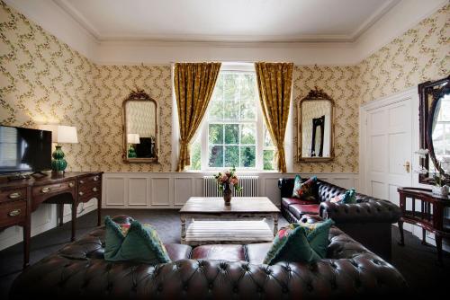 a living room with a couch and a table at Stone Court House in Maidstone