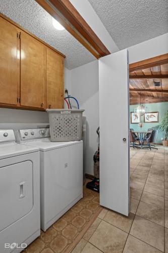 a kitchen with a stove and a washer and dryer at Cool Moss Stone Lodge Wkayaks & Canoes in Karnack
