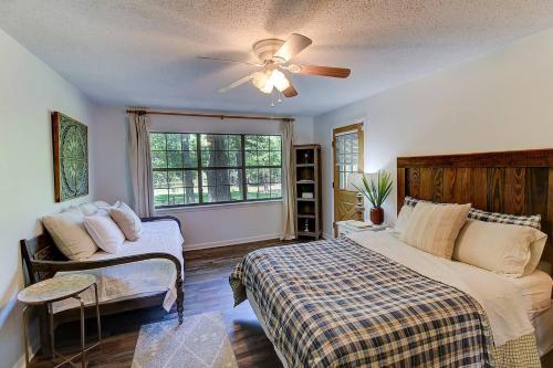 a bedroom with a bed and a ceiling fan at Avail This Weekend, Lakefront, Kayaks, Fenced in Shreveport