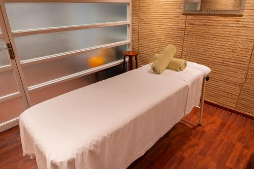 a room with a bed with a pillow on it at Terrado Suites Iquique in Iquique