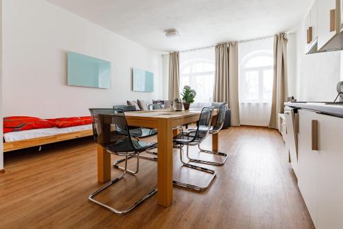 a kitchen and dining room with a table and chairs at Boží Apartments by Mountain ways in Boží Dar