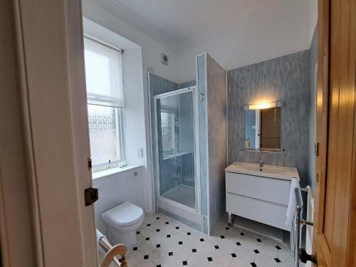 a bathroom with a toilet and a sink and a shower at Arden House - rooms with continental breakfast in Musselburgh