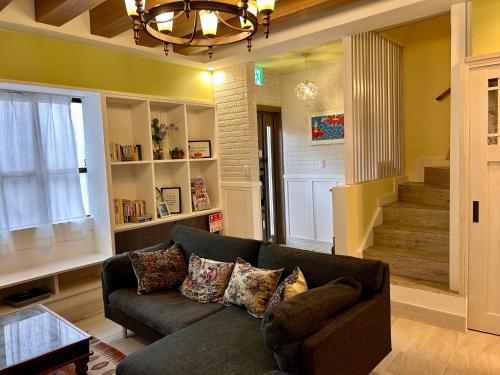 a living room with a couch and a staircase at 若狭の家 in Naha