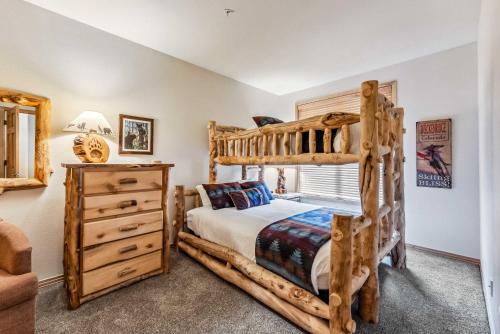 a bedroom with a wooden bunk bed and a dresser at Breckenridge Condo: Large Patio & Shared Amenities in Breckenridge