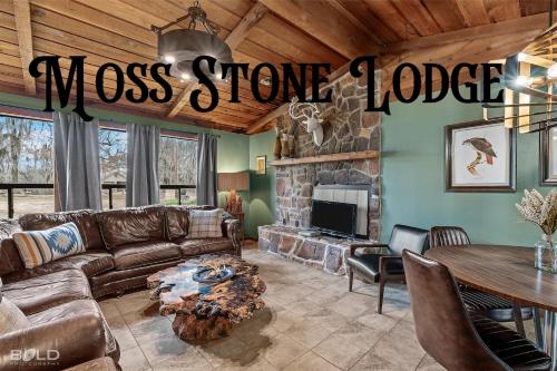 a living room with a couch and a fireplace at Cedar Wood Lodge Wkayaks & Canoes, Outdoor Dining in Karnack